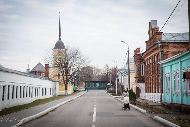 A woman walking her child along a quiet street in Kolomna’s historic district.