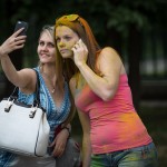 Russian women making a selfie after leaving the Color Festival held at a Moscow park.