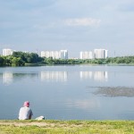 A Russian man resting near a pond in the south of Moscow.