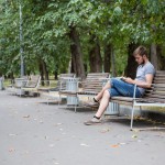 A university student reading a novel in an empty Moscow park.