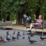 A pension feeding birds in a Moscow park - a common scene.