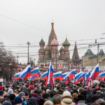 People carrying Russian flags during the rally as it approaches St. Basil's.