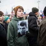A young man carrying a photo of Nemtsov during the rally.