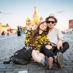 Inessa and Ostin sitting on Red Square for a photo.