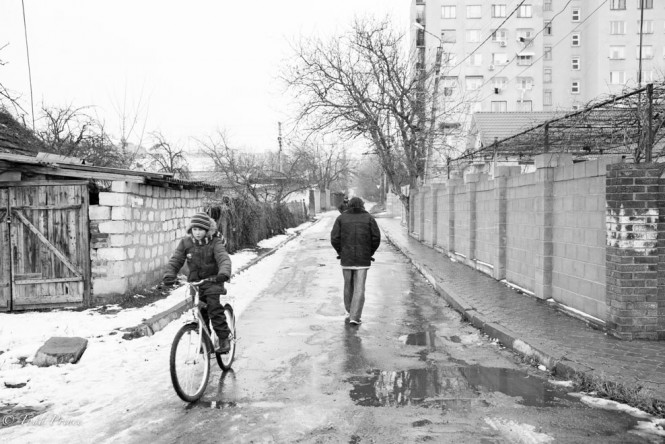 A young boy riding town a street in Tiraspol