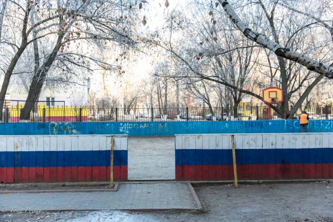 It's not only the homes that are painting. Here a fence surrounding a basketball and hockey playground is painted in the colors of the Russian flag. 