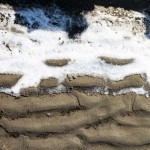 Snow on the sand in Sakhalin.