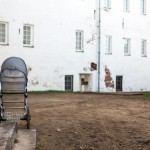 A baby carriage sits inside the monastery grounds.