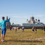 Russian and Ukrainian construction workers playing soccer in front of the Solovetsky Monastery they are helping restore.
