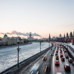 Steam rises from a power plant in the distance as traffic builds by the Kremlin.