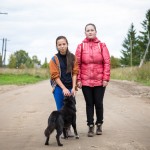 Two of Sergei's students on their way home after class. As the girl on the left approached her house, her dog came running up.